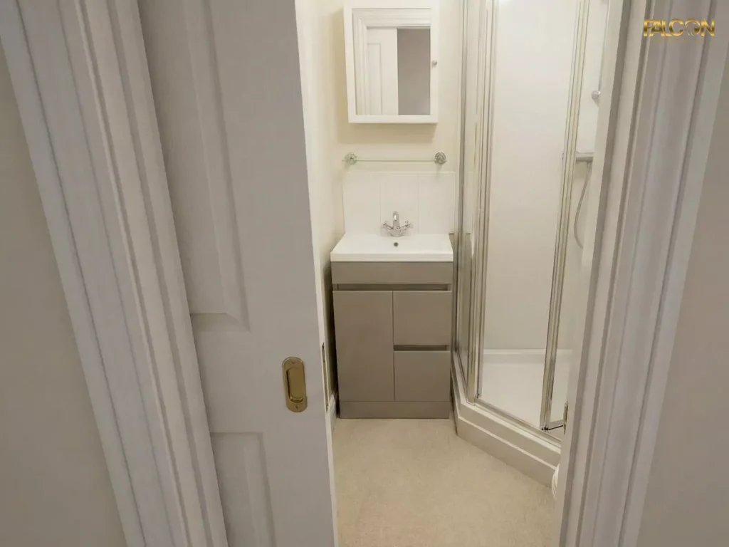 The same small bathroom with a pocket door slid into the wall, freeing up floor space and allowing for a larger, more functional vanity unit.